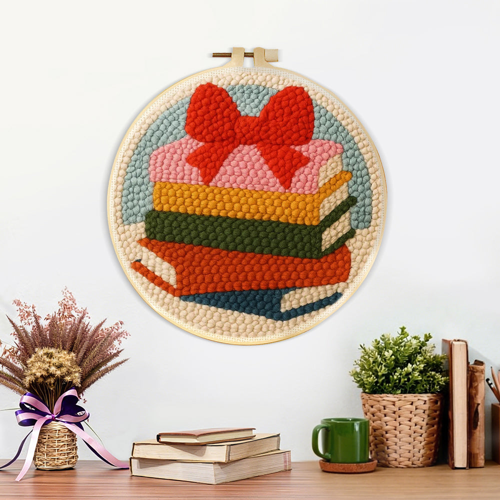 Finished colourful book stack with bow artwork displayed on a wall