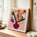 Colourful bouquet in burgundy vase punch needle artwork displayed on a table