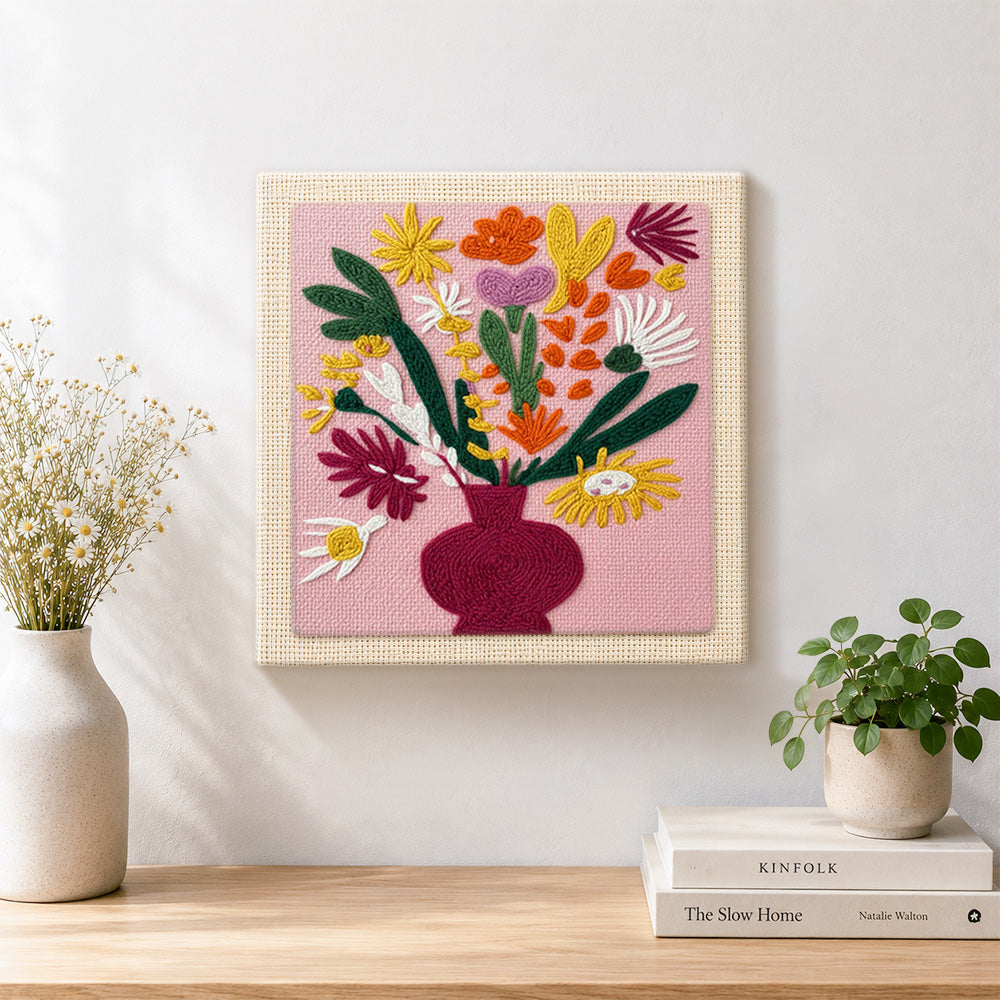 Finished colourful bouquet in burgundy vase artwork displayed on a wall