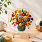 Finished colourful bouquet with berries needle felting displayed on a wooden easel