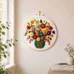 Colourful bouquet with berries needle felt wall art displayed in a bright home interior