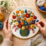 Creating the colourful bouquet with berries wool painting by hand with a felting needle