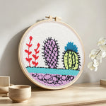 Colourful cactus trio punch needle artwork displayed on a table