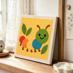 Colourful caterpillar punch needle artwork displayed on a table