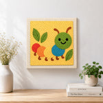 Finished colourful caterpillar artwork displayed on a wall