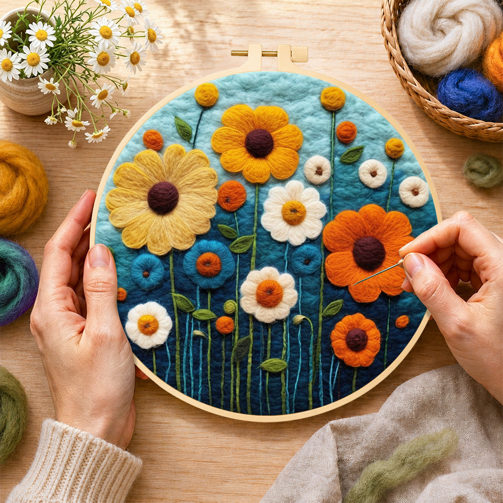 Creating the colourful daisies on dark blue wool painting by hand with a felting needle
