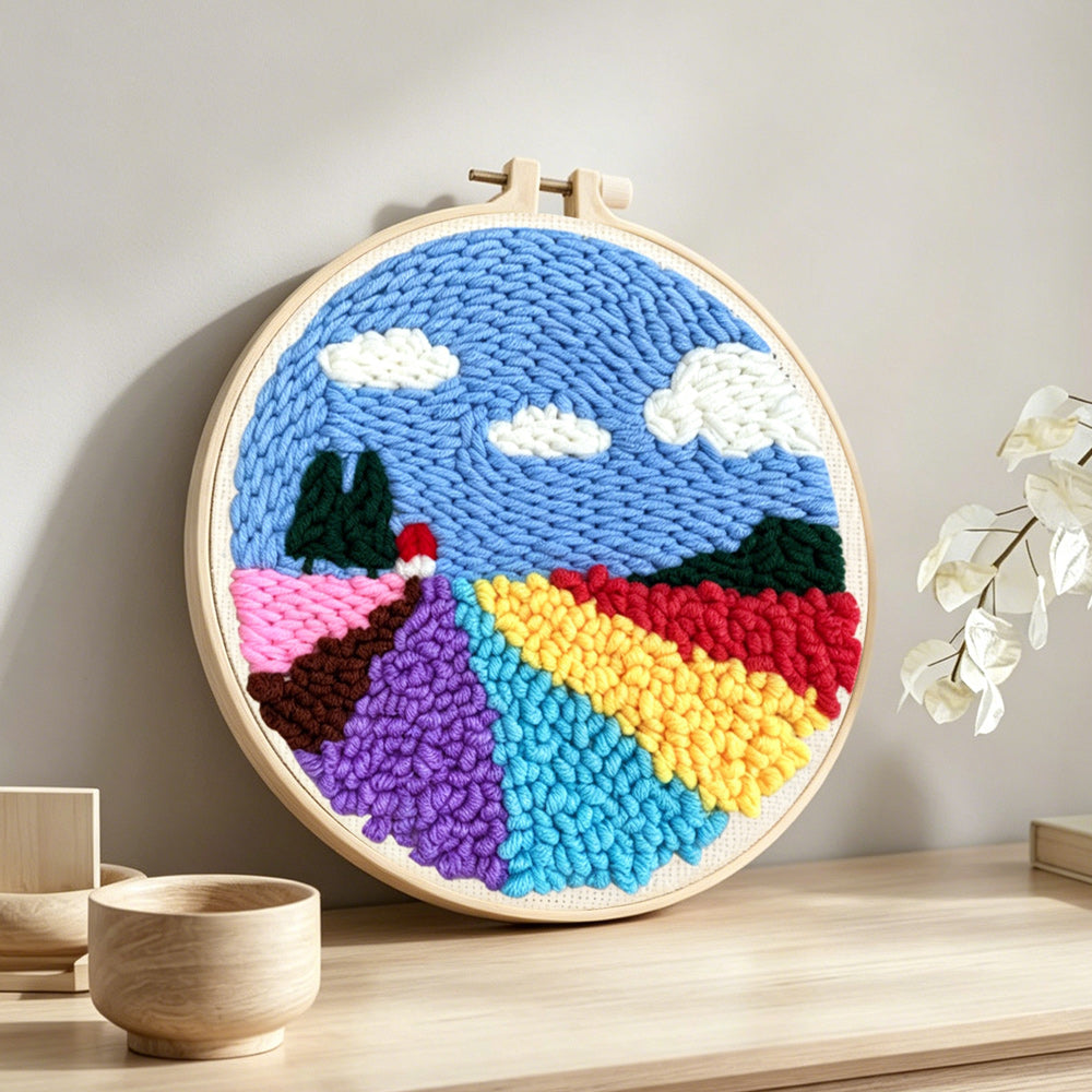 Colourful floral field punch needle artwork displayed on a table