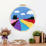 Finished colourful floral field artwork displayed on a wall