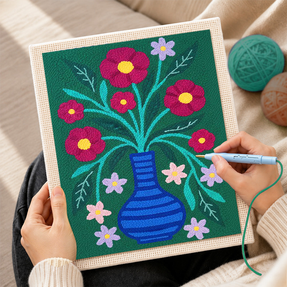 Creating handmade colourful flowers in striped blue vase punch needle artwork