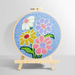 Colourful flowers on blue background punch needle kit for beginners