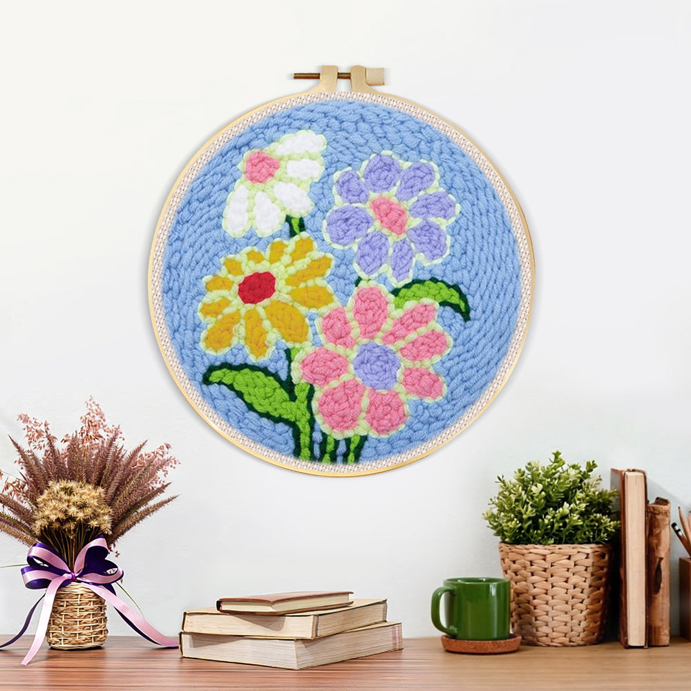 Finished colourful flowers on blue background artwork displayed on a wall