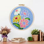 Finished colourful flowers on blue background artwork displayed on a wall