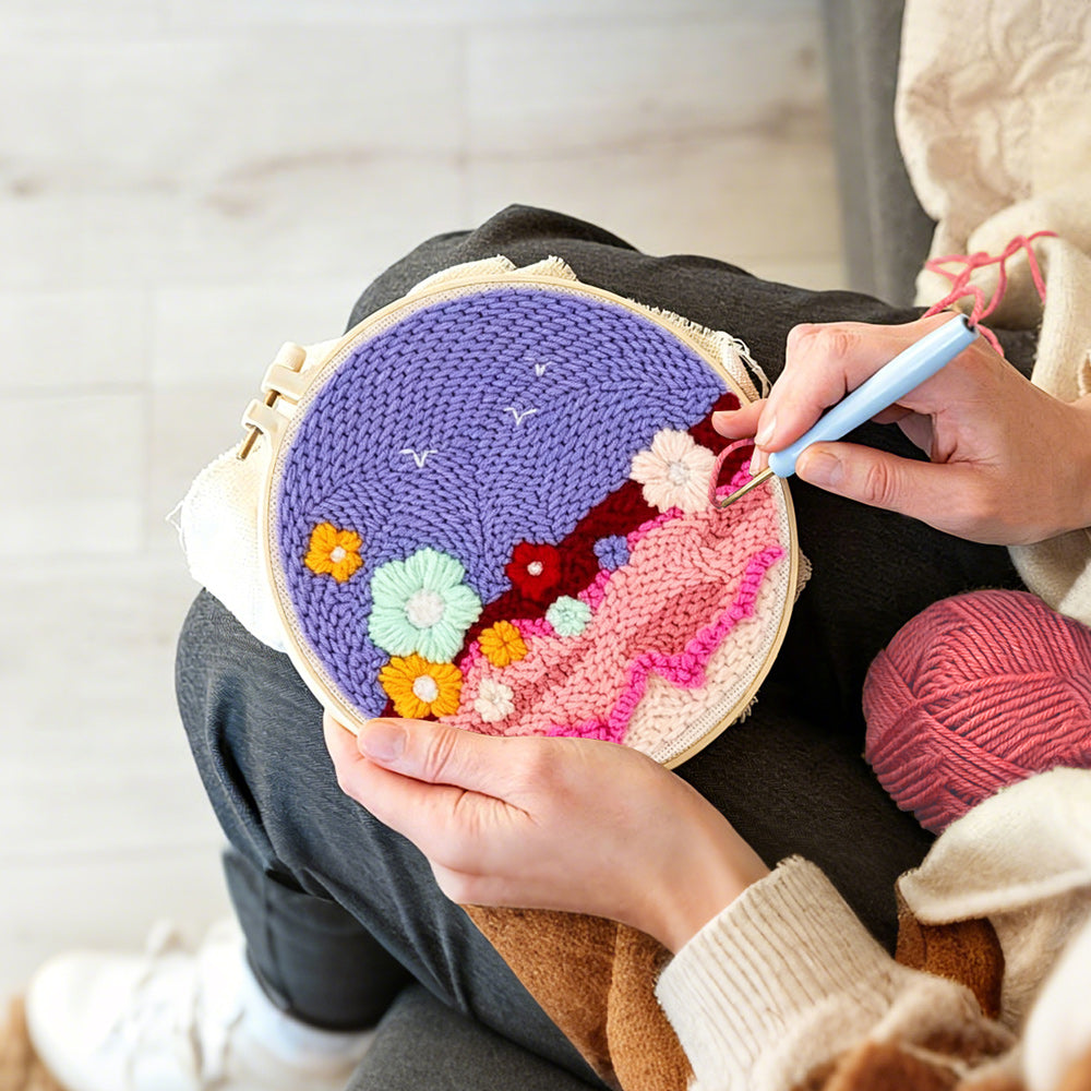 Creating handmade colourful flowers on purple sky punch needle artwork