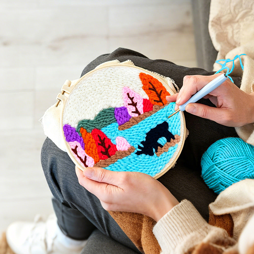 Creating handmade colourful forest above a lake punch needle artwork