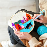 Creating handmade colourful forest above a lake punch needle artwork