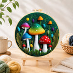 Finished colourful gradient mushrooms needle felting displayed on a wooden easel