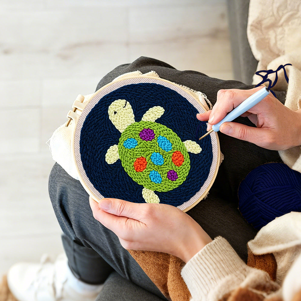 Creating handmade colourful little turtle punch needle artwork