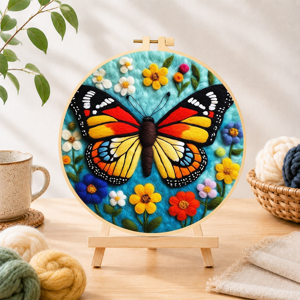 Finished colourful monarch butterfly and wildflowers needle felting displayed on a wooden easel