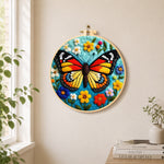 Colourful monarch butterfly and wildflowers needle felt wall art displayed in a bright home interior