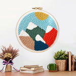 Finished colourful mountain landscape artwork displayed on a wall