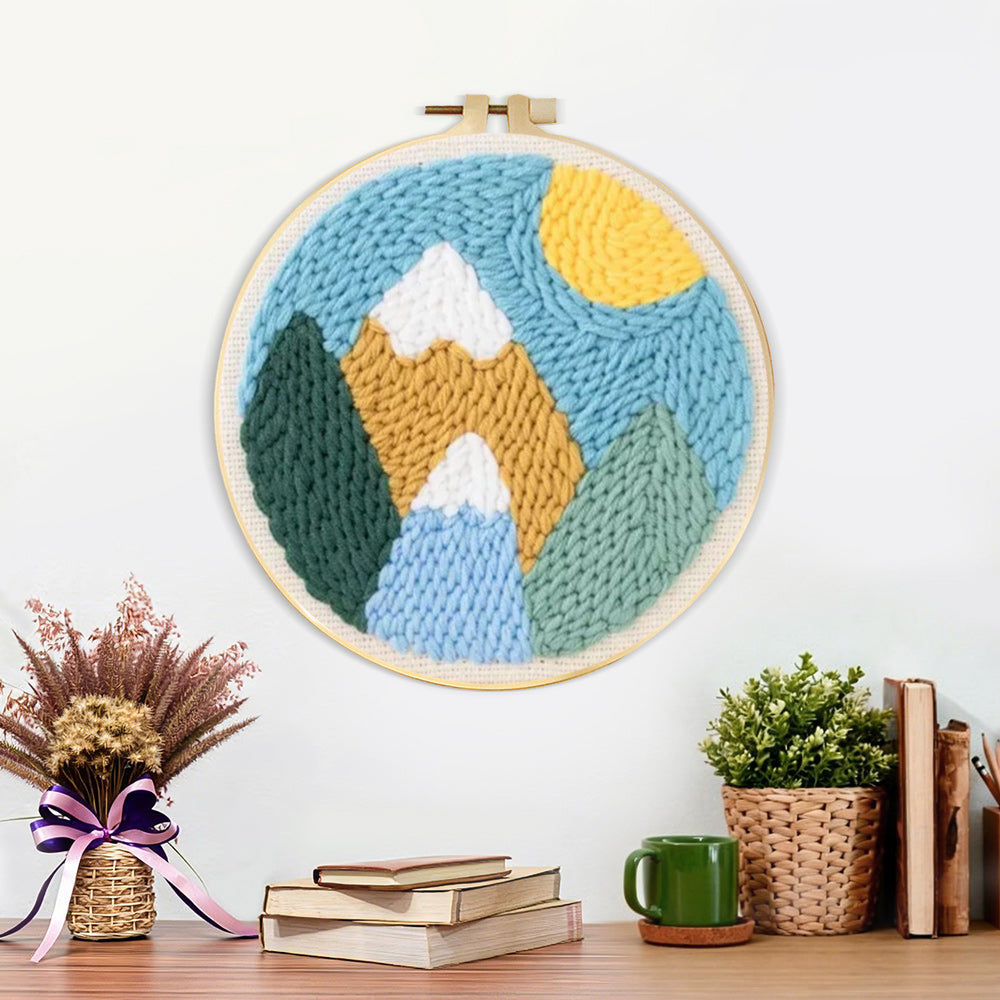 Finished colourful mountain landscape with sun artwork displayed on a wall