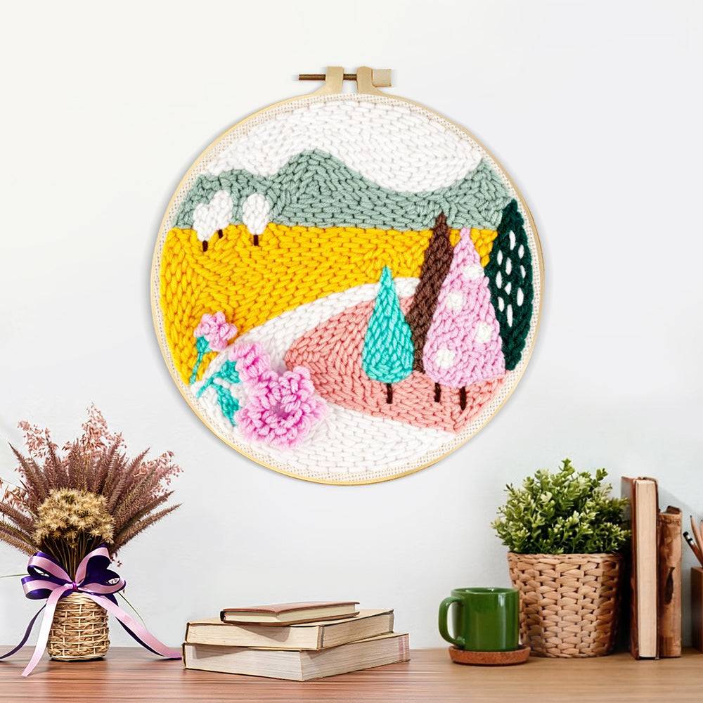 Finished colourful mountains and trees artwork displayed on a wall