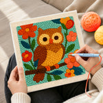 Creating handmade colourful owl on flowering branch punch needle artwork