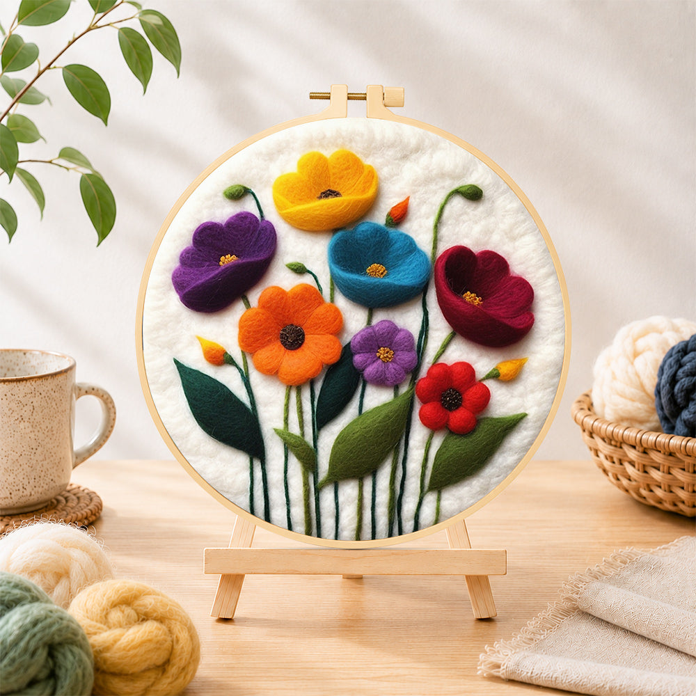 Finished colourful poppies needle felting displayed on a wooden easel