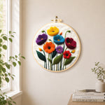 Colourful poppies needle felt wall art displayed in a bright home interior