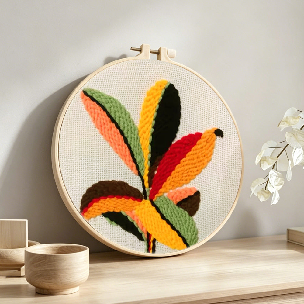 Colourful radial leaves punch needle artwork displayed on a table