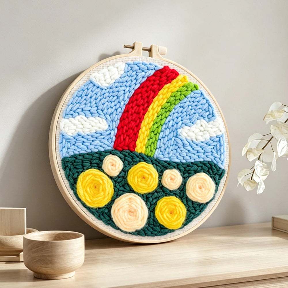 Colourful rainbow with yellow roses punch needle artwork displayed on a table