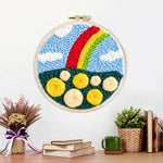 Finished colourful rainbow with yellow roses artwork displayed on a wall