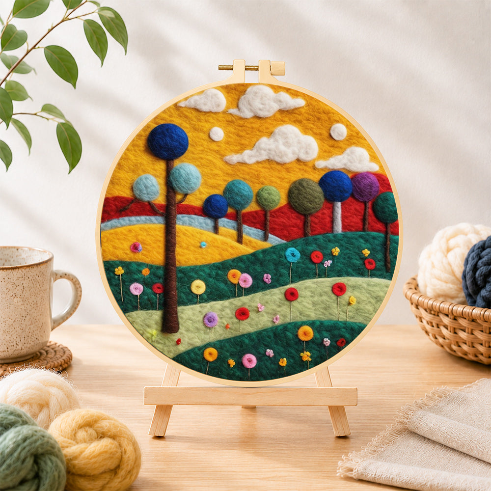 Finished colourful round trees on whimsical hills needle felting displayed on a wooden easel