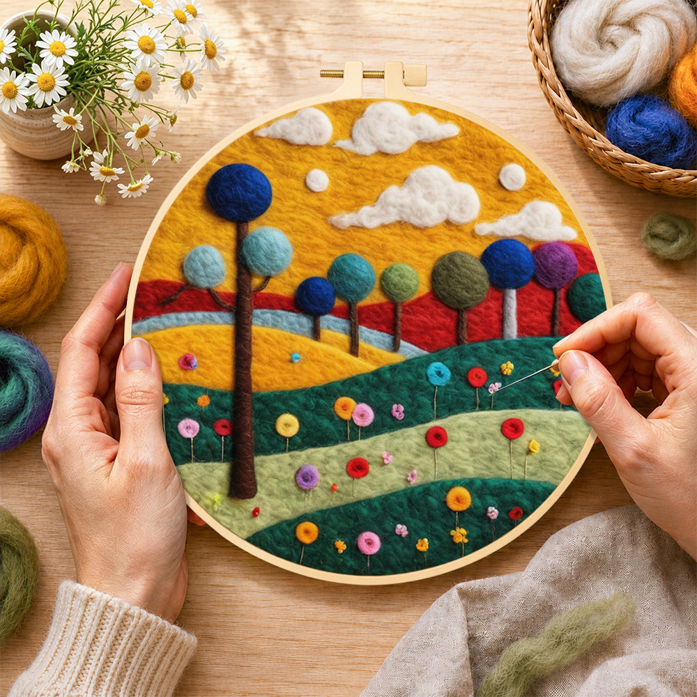 Creating the colourful round trees on whimsical hills wool painting by hand with a felting needle
