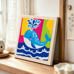 Colourful spouting whale punch needle artwork displayed on a table