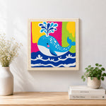 Finished colourful spouting whale artwork displayed on a wall