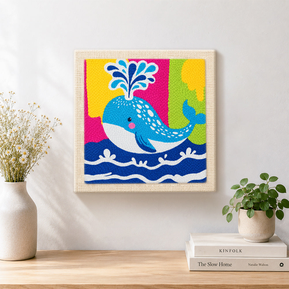 Finished colourful spouting whale artwork displayed on a wall