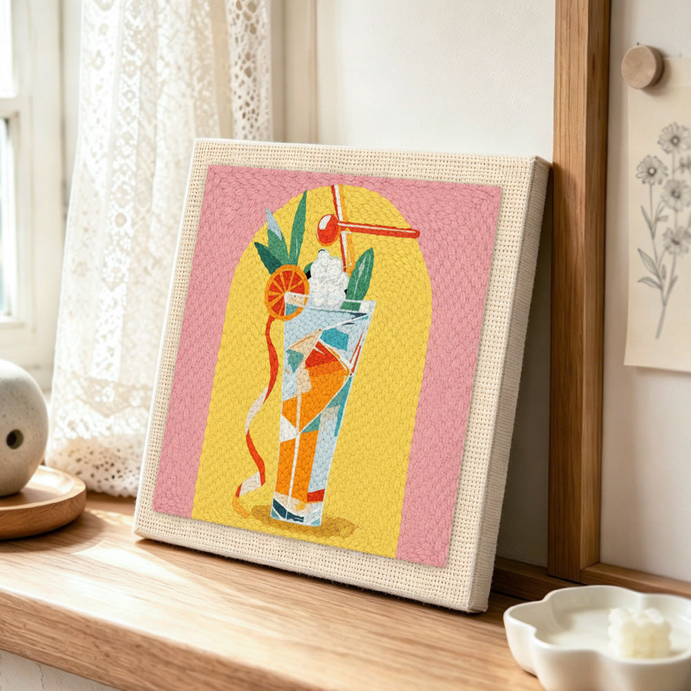 Colourful tall cocktail punch needle artwork displayed on a table