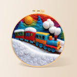 Colourful train on snowy hills needle felting kit for beginners with a round wooden frame