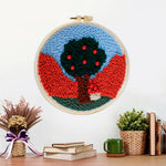 Finished colourful tree with red beads artwork displayed on a wall