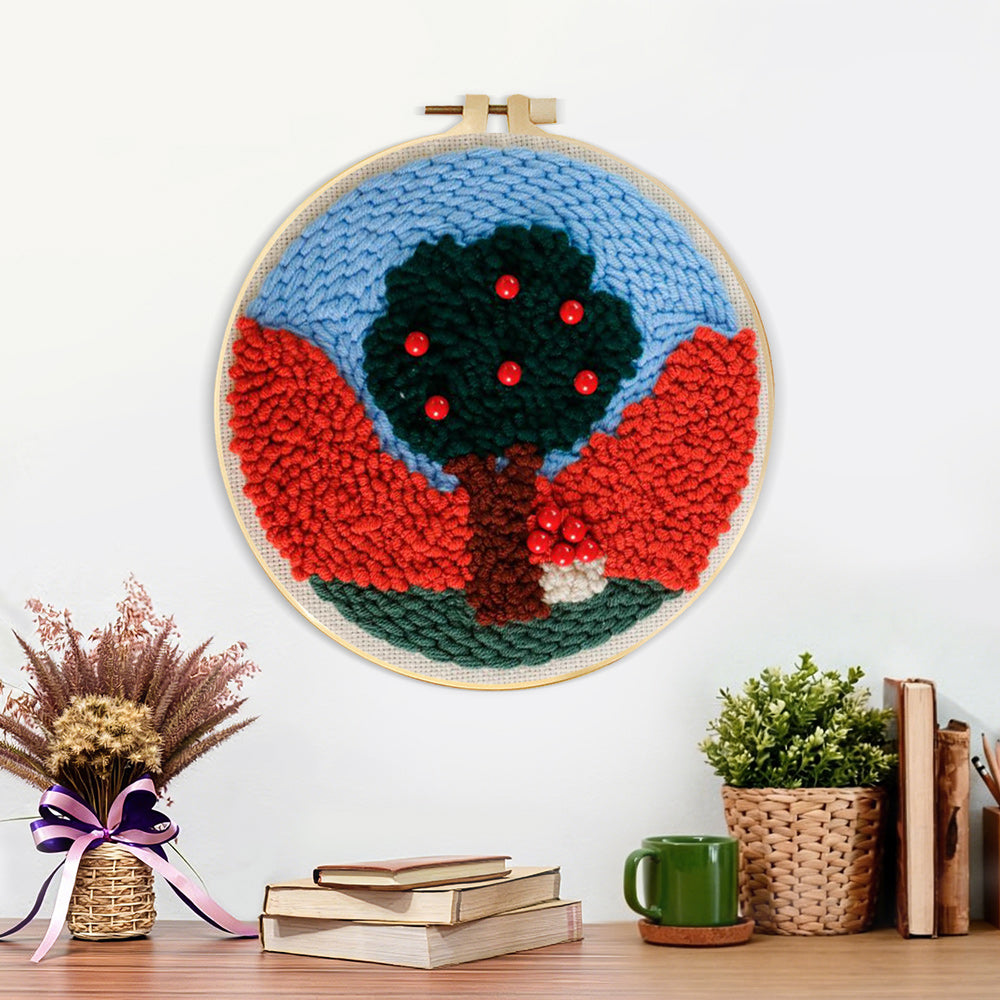 Finished colourful tree with red beads artwork displayed on a wall