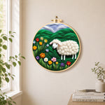 Colourful wildflower meadow with a sheep needle felt wall art displayed in a bright home interior
