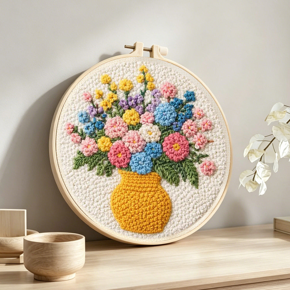 Colourful wildflowers in yellow vase punch needle artwork displayed on a table