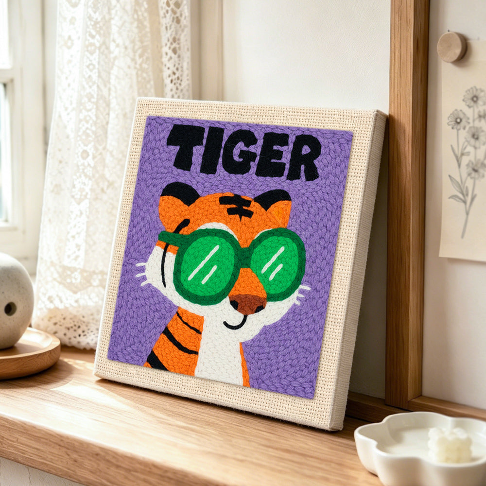 Cool "TIGER" with green sunglasses punch needle artwork displayed on a table