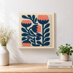 Finished coral and navy flowers artwork displayed on a wall