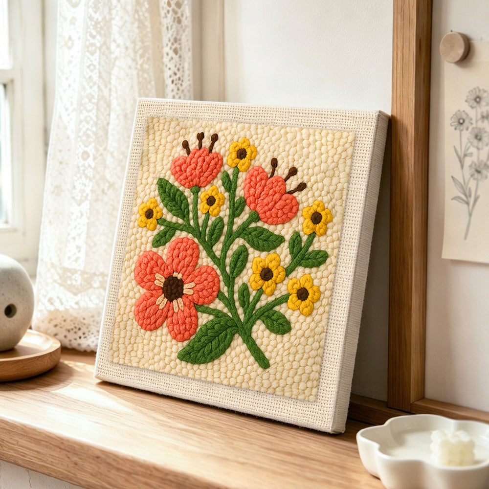 Coral and yellow florals punch needle artwork displayed on a table