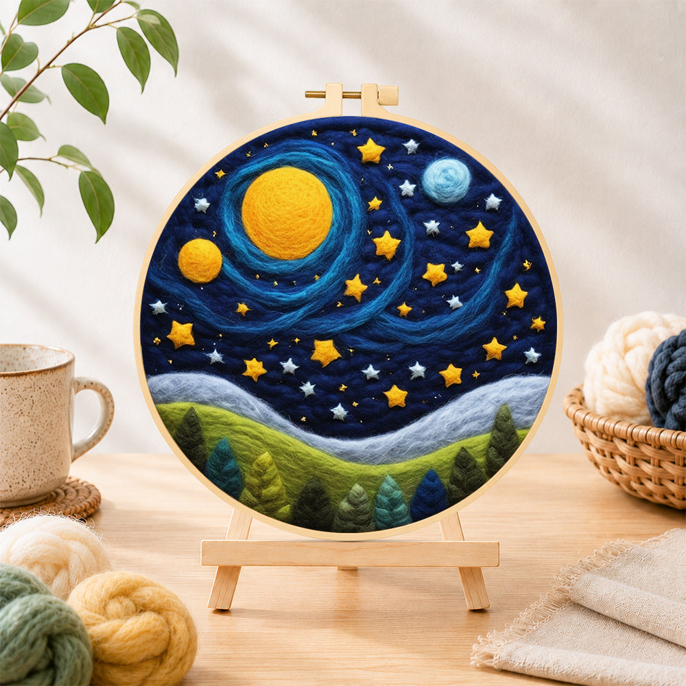 Finished cosmic planets and starry forest night needle felting displayed on a wooden easel