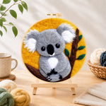 Finished cosy grey koala needle felting displayed on a wooden easel