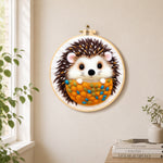 Cosy hedgehog needle felt wall art displayed in a bright home interior