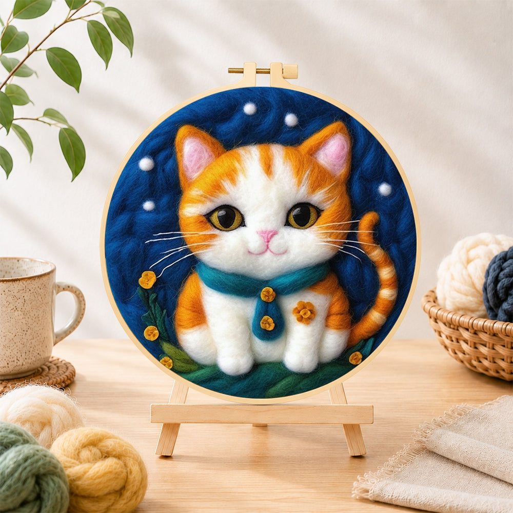 Finished cosy orange cat with teal bow tie needle felting displayed on a wooden easel